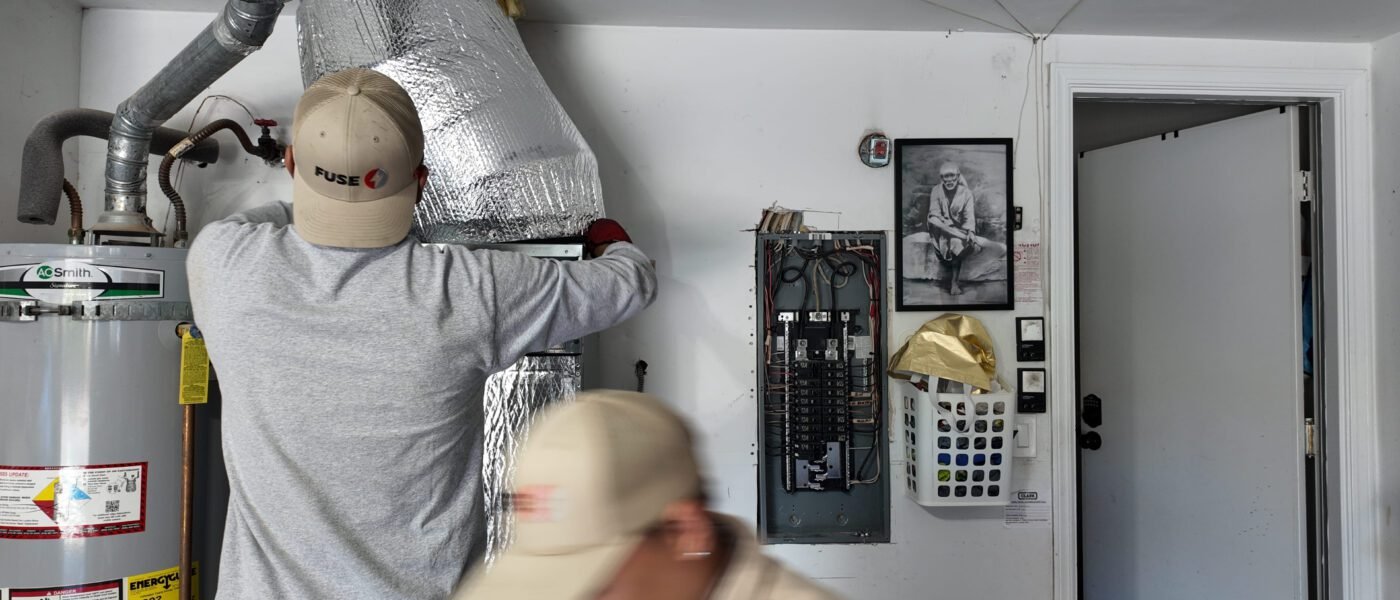 HVAC technician installs an air conditioner at the best time to buy an air conditioner