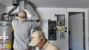HVAC technician installs an air conditioner at the best time to buy an air conditioner